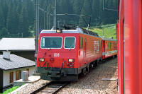 Zugkreuzung in Dieni: HGe 4/4 Nr. 108 hat einen Teil des Glacier-Express am Hacken